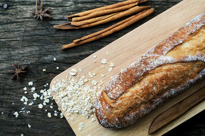 Top view of freshly baked traditional italian ciabatta breads prepared and sliced on a wooden table