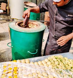 Midsection of man preparing food at market stall