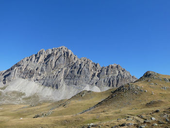 Scenic view of rocky mountains against clear blue sky