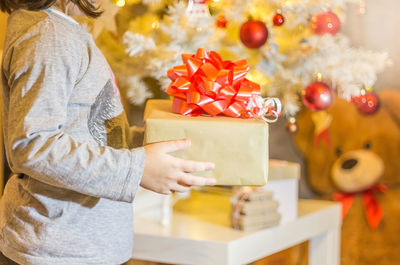 Close-up of woman holding christmas decorations