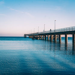 Bridge over sea against blue sky