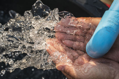 Close-up of hand holding ice crystals