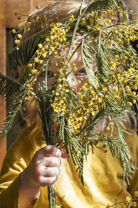 Midsection of woman holding christmas tree