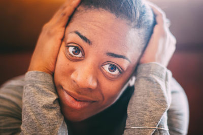 Close-up portrait of young woman sitting at home