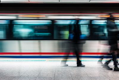 Blurred motion of train at railroad station