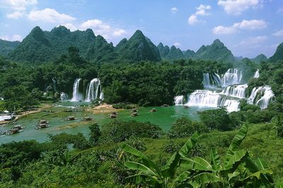 Scenic view of waterfall against sky