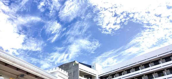 Low angle view of buildings against sky on sunny day