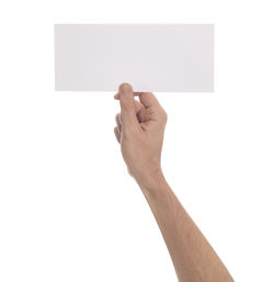 Low angle view of hand holding paper against white background