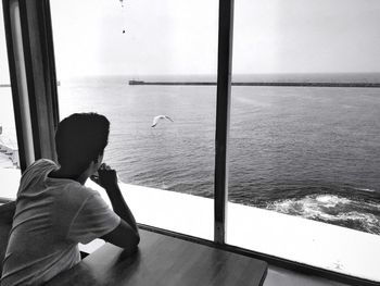 Rear view of man looking at sea
