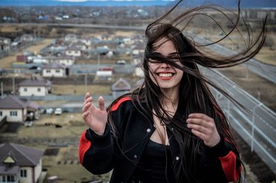 Young woman wearing sunglasses standing outdoors