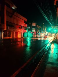 Illuminated city street at night