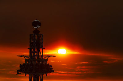 Low angle view of silhouette tower against sky during sunset