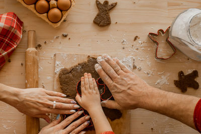 Cropped hands of person preparing food on table