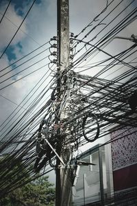 Low angle view of electricity pylon against sky