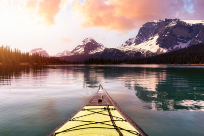 Scenic view of lake and mountains against sky during sunset