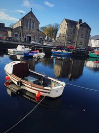 Boats in river with buildings in background