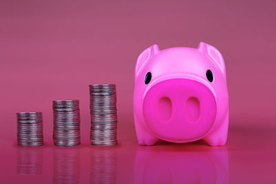 Close-up of pink coins over black background