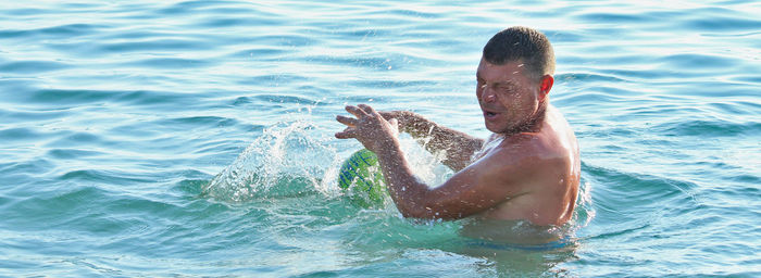 Portrait of man swimming in sea