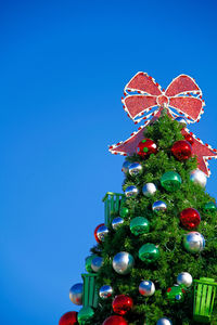Close-up of christmas tree against clear blue sky