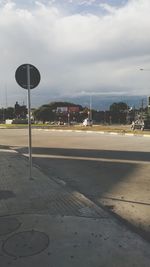 City street against cloudy sky