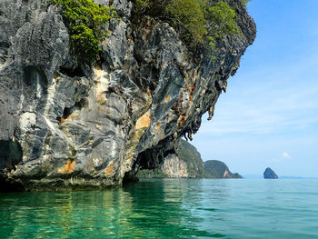 Scenic view of rocks in sea against sky