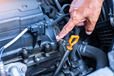 Cropped hand of man repairing car