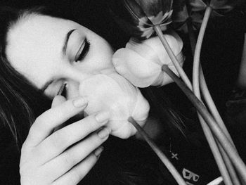 Close-up portrait of woman holding flowers