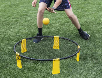 Low section of man playing with ball