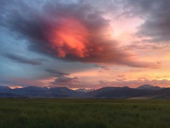 Scenic view of mountains against cloudy sky