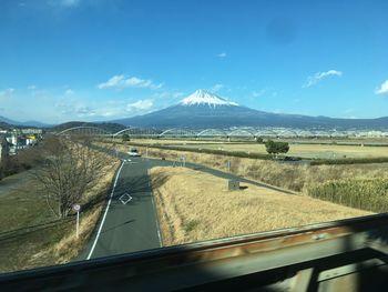 Panoramic view of road seen through car windshield