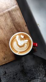 Double-winged swan pattern on a cup of cappuccino.