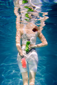 Low section of woman swimming in pool