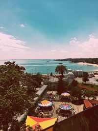 Swimming pool by sea against sky