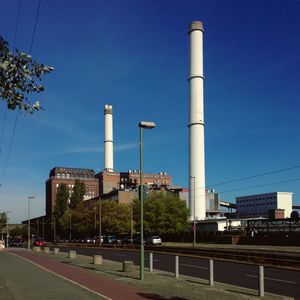 View of factory against blue sky