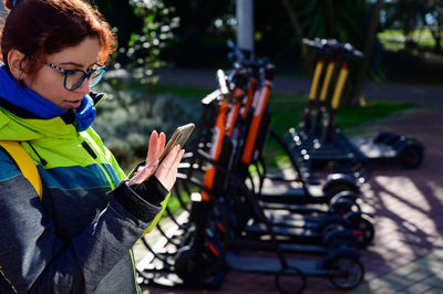 Portrait of young woman with bicycle