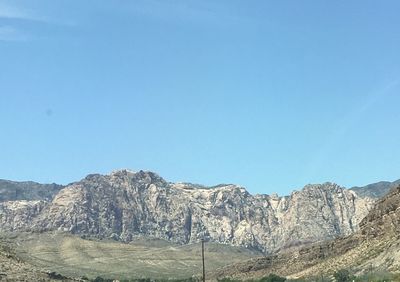 Scenic view of mountains against clear blue sky