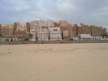 Buildings on beach against sky in city