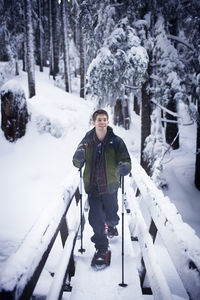 Young hiker on footbridge in winter