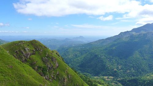 Scenic view of mountains against cloudy sky