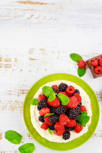 High angle view of strawberries in plate on table