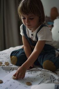 Boy drawing on bed at home