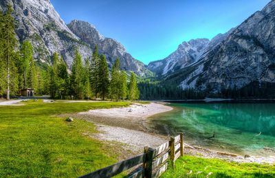 Scenic view of lake by mountains against sky