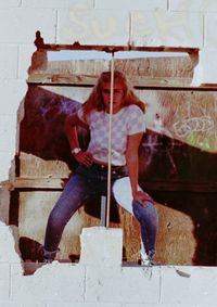 Full length of young woman sitting outdoors