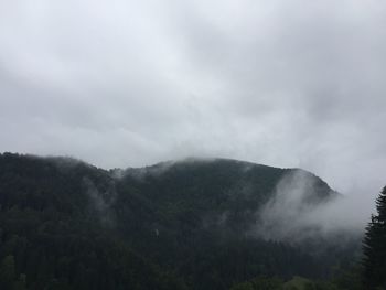 Scenic view of mountains against cloudy sky