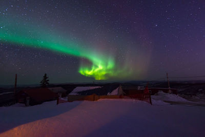 Scenic view of snow covered mountain against sky at night