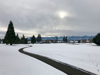 Snow covered field against sky