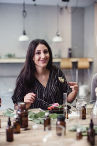 Portrait of a smiling young woman at home