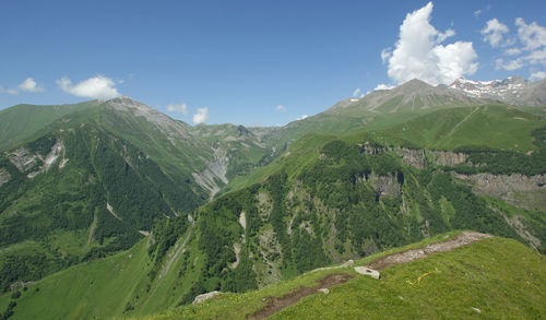 Scenic view of green mountains against sky