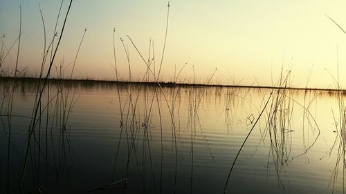 Scenic view of lake against sky during sunset