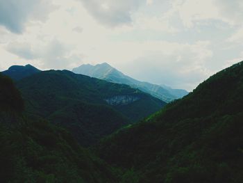 Scenic view of mountains against cloudy sky